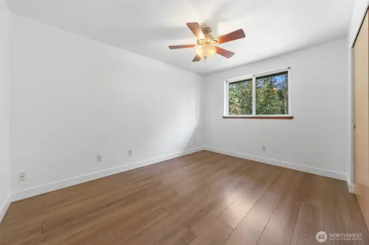Large bedroom with ceiling fan, nice size window making this room light and bright.