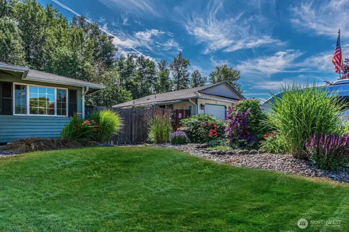 Professional like landscaping, easy maintenance and beautiful flowerbeds welcome you home as you drive up.