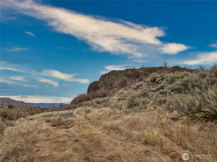 Lower tier north view has shale and level space for RV/camper trailer parking
