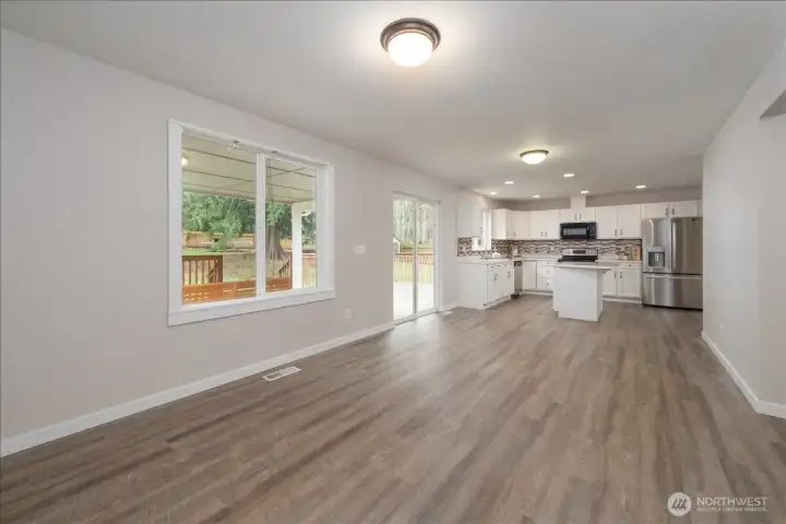 Main house: Living room, kitchen, and backyard deck access on main floor.