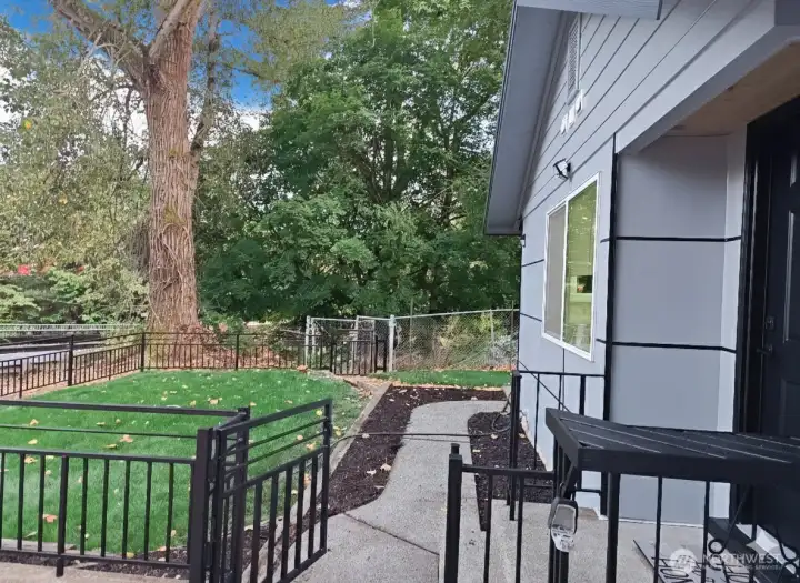 Private front walkway surrounded by greenery — peaceful, clean, and freshly updated. Step inside and feel the calm right from the front gate.