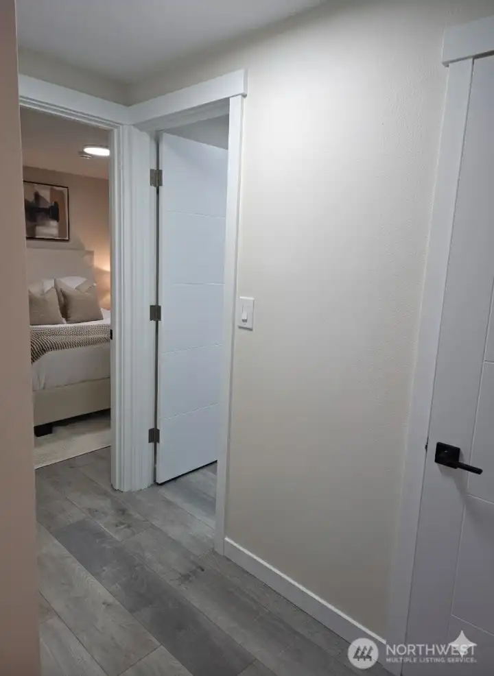 Compact hallway connecting the bedrooms and bathroom, designed with clean modern lines and soft neutral tones that make the space feel bright and cohesive.