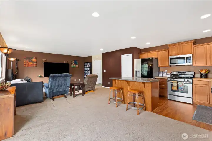 Open-concept main floor connects living, dining, and kitchen areas, maximizing space and natural light.