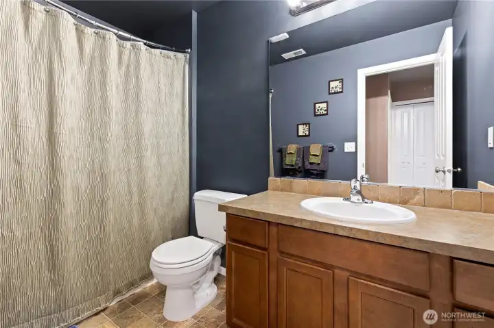 Hall bathroom with tub/shower combo, clean finishes, and functional layout.