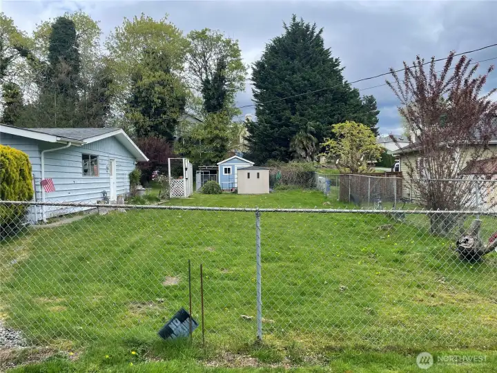 Side yard with pool shed and tool shed.