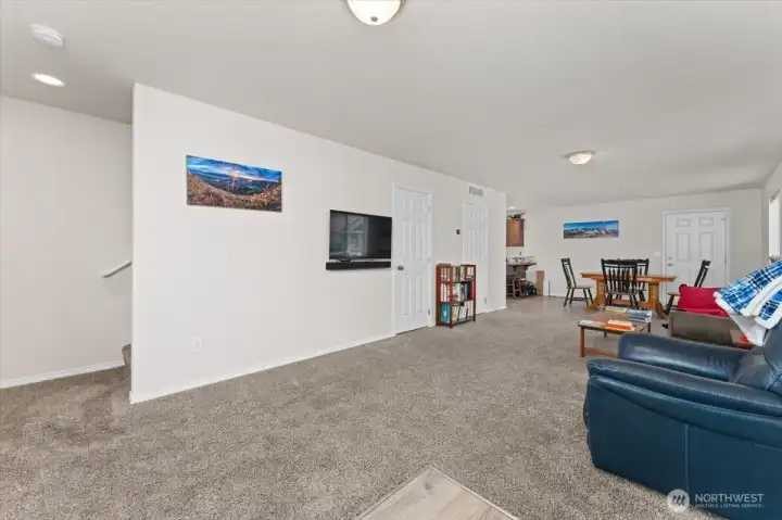 Living room with stairs to the left, 1/2 bath & storage in front and dining room to the right.