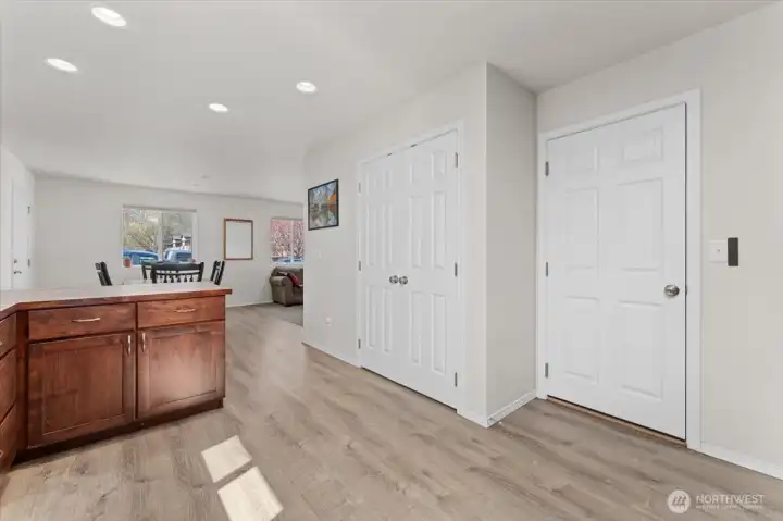 From the kitchen and looking towards the dining room. Door to the garage is to the right.