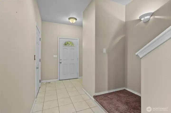 Entry with access to garage and upstairs