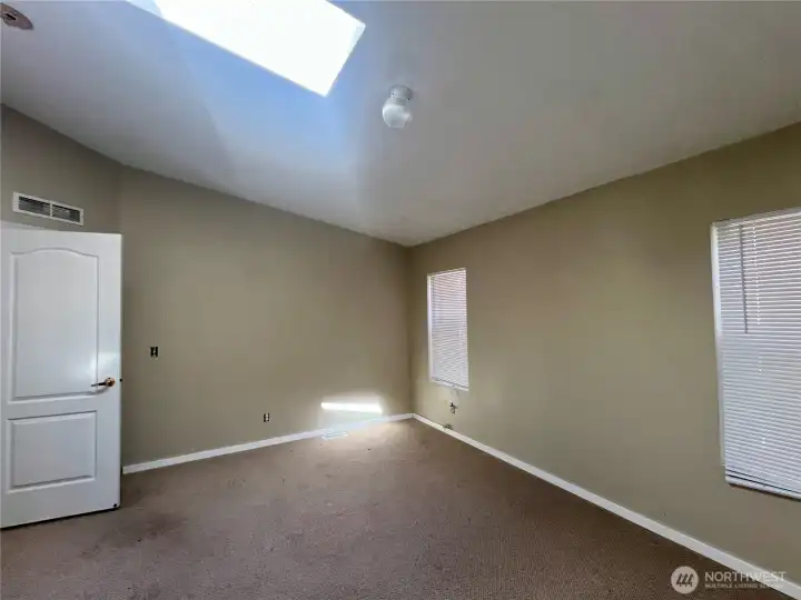 Primary bedroom features vaulted ceilings, walk in closet and large bath