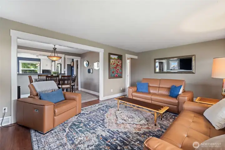 Warm and inviting gathering space with timeless brick fireplace, built-in shelving, and abundant natural light.