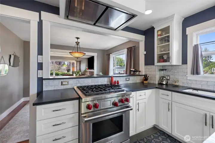 Higher end Wolf Range and Stainless steel high CFM vented hood. Carrara marble backsplash and honed quartz countertops.