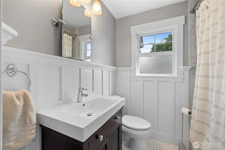 Main floor full bath with updated vanity and fixtures.