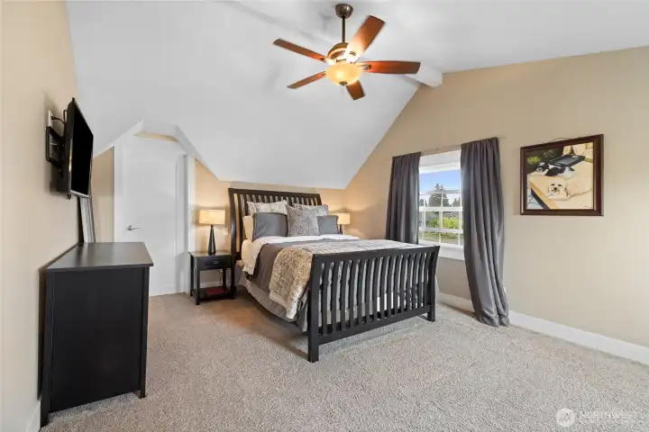 Primary bedroom with sitting area and walk in closet.