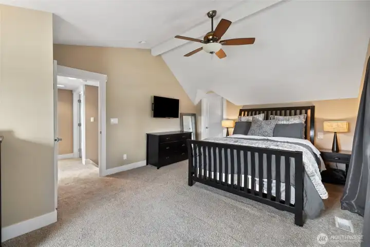 View of Primary bedroom with view of hallway in the distance. Sitting area (not pictured) looks to backyard.