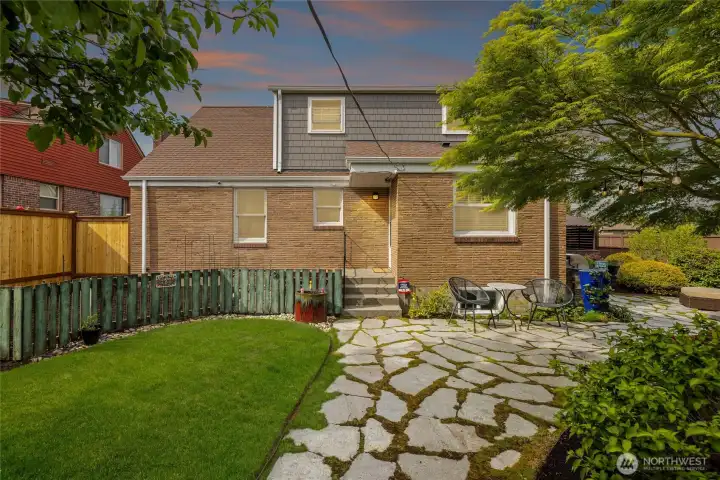 Fully fenced backyard with manicured lawn, mature trees, entertaining patios, and charming rear exterior access. Separate enclosed garden space is vegetable plant ready, serves as a perfect location for tomatoes with the exposure of the sun next to the home. Home has been replaced with Hardi-siding on upper shed dormer.