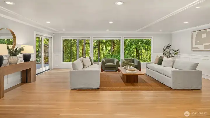 You’re welcomed by the home’s generously sized living room, perfectly positioned to overlook the lush backyard greenery.