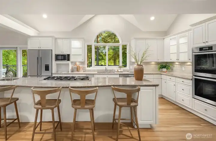 Chef’s kitchen with granite countertops, refreshed cabinetry, walk-in pantry, and extensive storage.