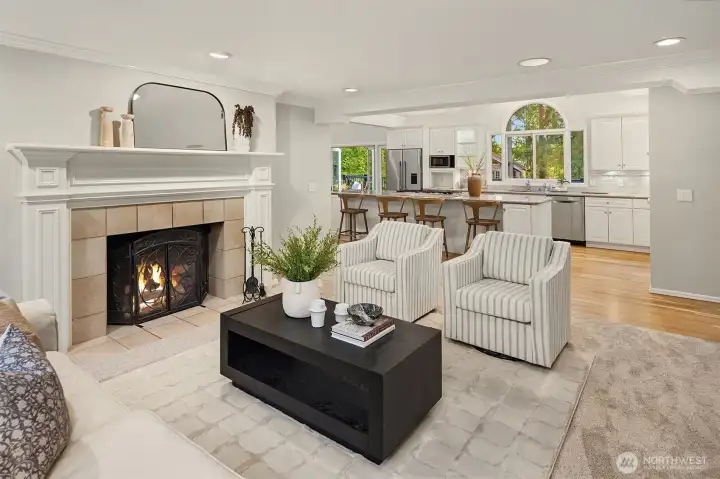 Inviting living space just off the kitchen featuring a cozy wood-burning fireplace.
