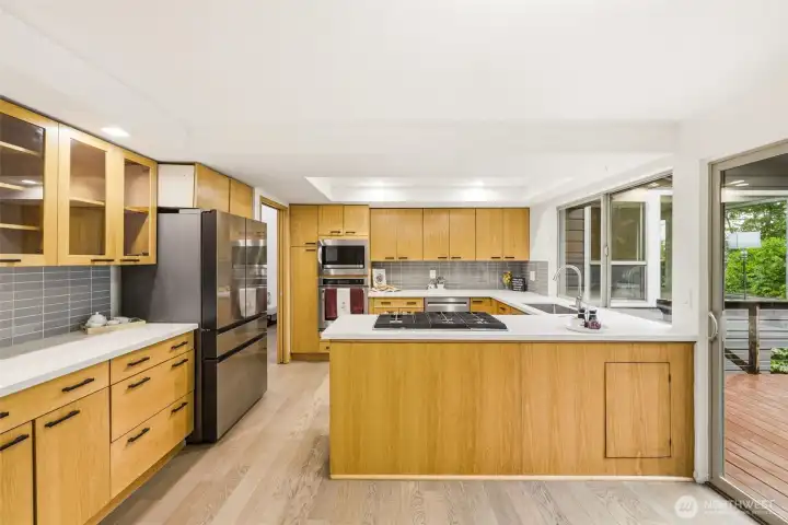 Updated Kitchen with Island and Deck Access Updated Kitchen with Island and Deck Access