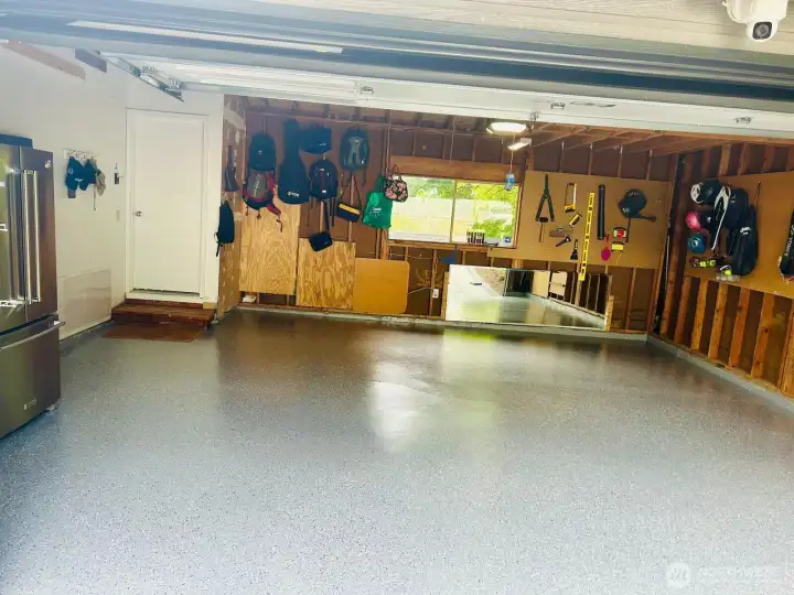Garage with Epoxy-Coated Floor and Storage Potential Garage with Epoxy-Coated Floor and Storage Potential
