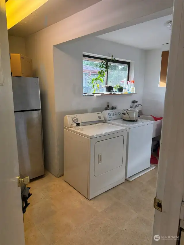 Laundry room in a large utility room just outside the kitchen.