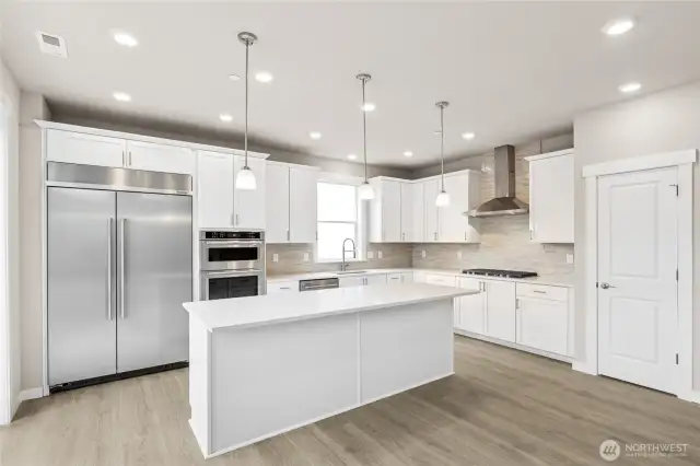 Gorgeous kitchen with tons of space to prepare!  48" counter depth refrigerator, built in microwave & oven + gas cooktop!
