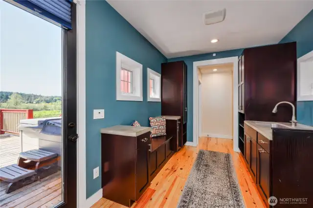 The breezeway has a utility sink, lots of storage, access to the garage and suite above, and a door to the back deck.