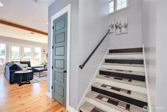 Access to the bedrooms upstairs is off of the main entry hallway. Note the door to under-stair storage with the custom 8-foot high door. What a nice touch!