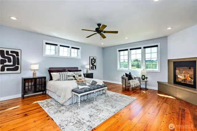 The expansive primary suite allows you to take in the views while being warmed by the gas fireplace. The wood floors throughout this special home are a lovely touch.