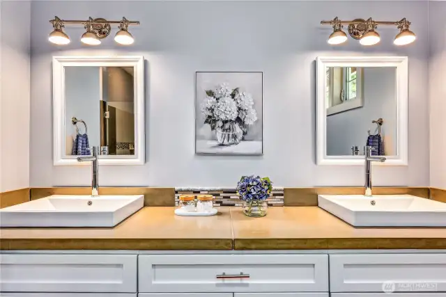 Dual sinks, contemporary design, and lots of storage space make this a bathroom you will love!