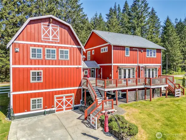 From the back side of the house you can see the large patio, the doors under the garage to the flex space, the back deck complete with motorized awnings, and that hot tub just waiting for you. There is so much possibility for enjoyment here!