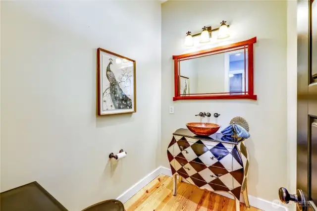 A charming powder room is also off the main entry, convenient for guests!