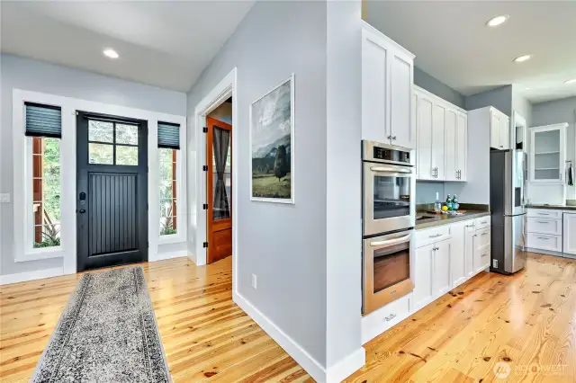 The chef's kitchen is off of the main entry, past the den and powder rooms. Note the wood floors throughout - no carpet!