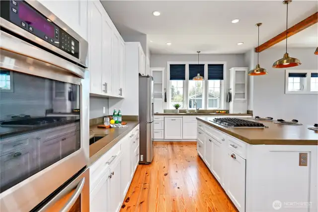 This kitchen is all you could imagine. Newer appliances, dual sink locations, double ovens, gas cooktop, tons of storage, 3 trash/recycling bins, huge walk-in pantry and so much more!