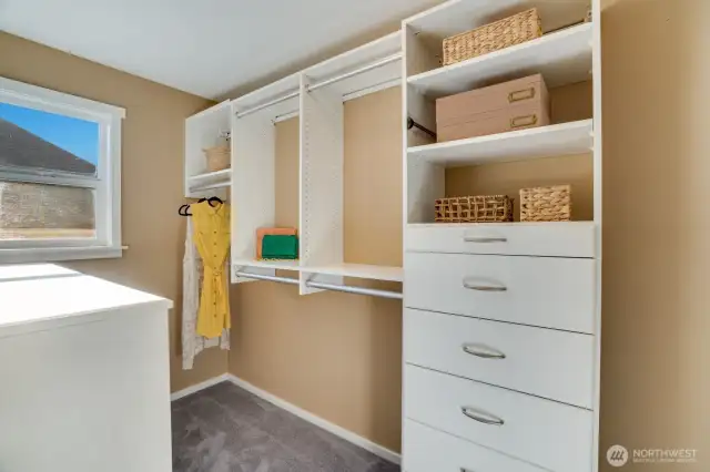 Walk-in closet with built-in hanging and drawer space