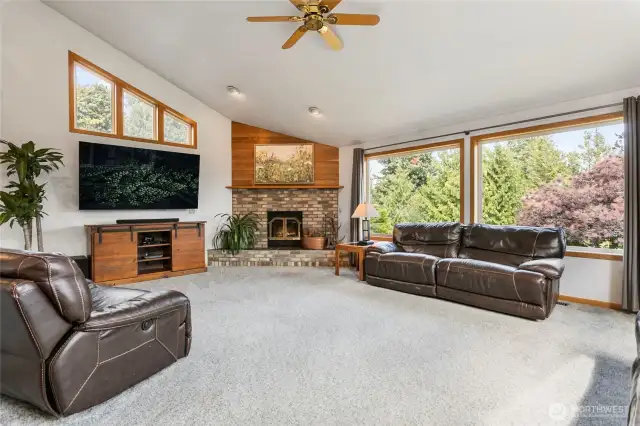 Living room with vaulted ceilings and wood fireplace