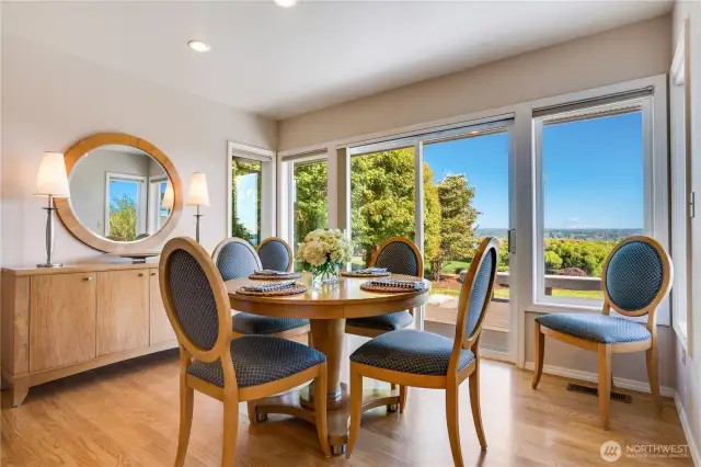 The inviting dining area, with direct access to a spacious deck, enhances the seamless indoor-outdoor flow.