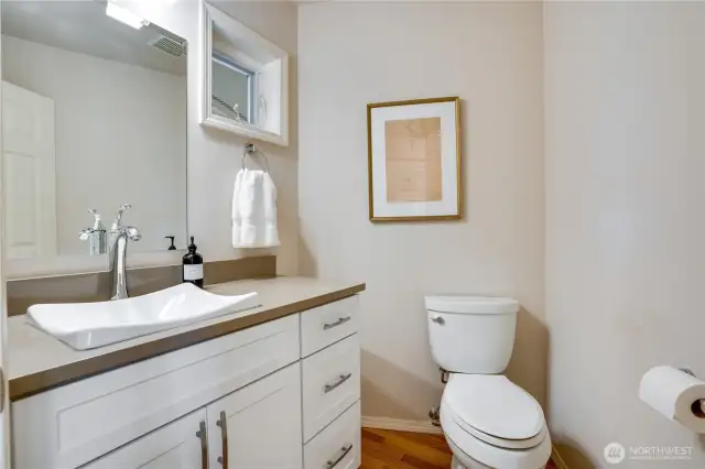 A convenient powder bathroom off the entryway hallway adds functionality.