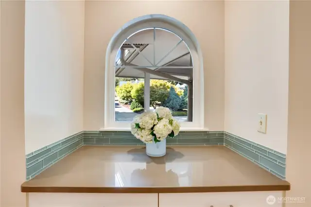 Built-in shelving and framed window over looking the front yard.
