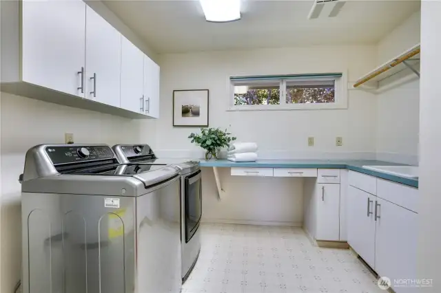 The thoughtfully designed utility room, boasting generous storage and a convenient prep-sink.