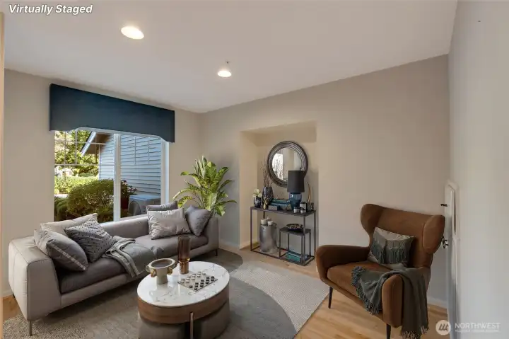 Upon entering, you’re greeted by a welcoming formal living room—an elegant space with large windows that fill the room with natural light. [Photo is virtually staged]