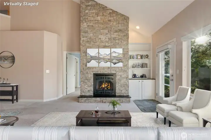 Centered around a warm gas fireplace, this space is perfect for movie nights, game days, or curling up with a book. [Photo is virtually staged]