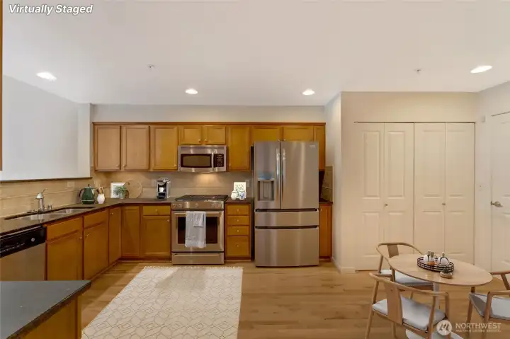 Eat-in kitchen with stunning hardwood flooring. [Photo is virtually staged]