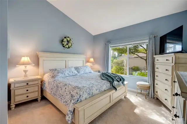 The main-level primary suite is a true retreat, complete with like-new carpet, a spacious walk-in closet, and a private ensuite bath.