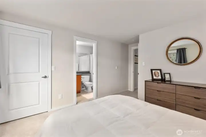 Primary bedroom, view of full bath, walk in closet to the left
