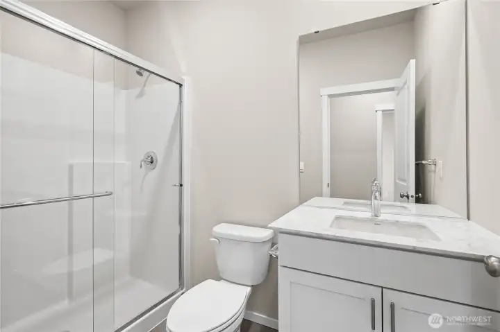 Main level 3/4 bath adjacent to main level bedroom.