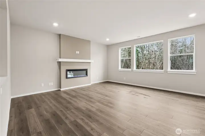 Great Room showcasing the Fireplace and the Large Windows with an abundance of natural light.