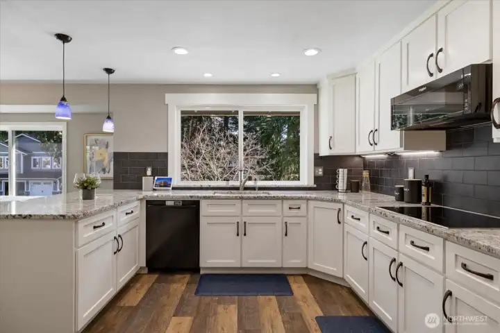 Nice door handles and finish work, with beautiful backsplash that really works well with the lighter granite counters.  Deep elongated sink that makes it so much easier with the pots and dishes!