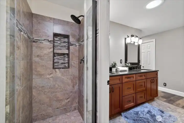 Enjoy the tiled shower with seemless glass shower door and a privacy glass door leading into it allowing more light!