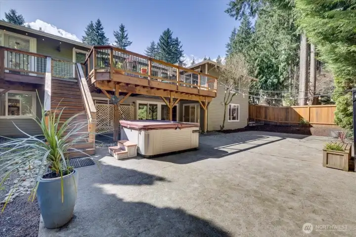 Big backyard with Pickleball sized court, hot tub that has been well taken care of!  Fully gated with a newer section of fence recently installed.  Stairs leading back up to the deck on the Main floor! Sliders leading to the basement.  Plenty of R and R to be had.  Also party lights strung back and forth for even for magical evenings!